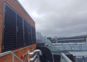 External side of the brick building with louvres built into the brick.