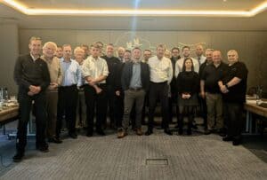 A group photo of the sales, marketing and leadership team stood in the meeting room at Boulevard Hotel